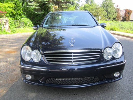 This 2006 C55 AMG is easily identified by the mesh grille on the lower fascia. It is borrowed from the CLK 55 AMG coupe, the double oval headlights are standard across the W203 line. Although the silver 5 bar silver grille is the signature style for these cars, a charcoal mesh unit can be fitted for a racier look.