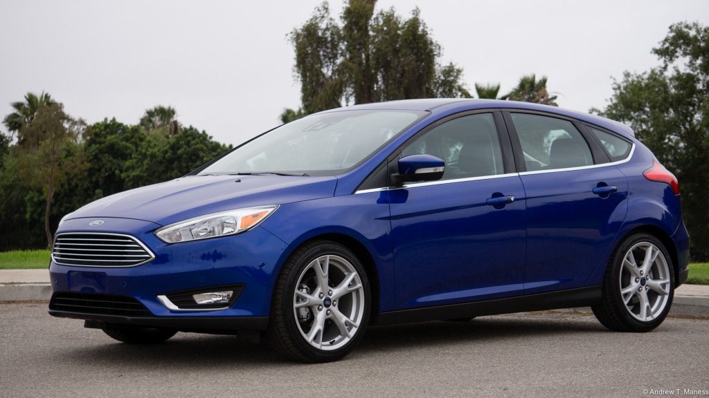 Dark Blue Ford Focus Hatchback parked in front of a golf course.